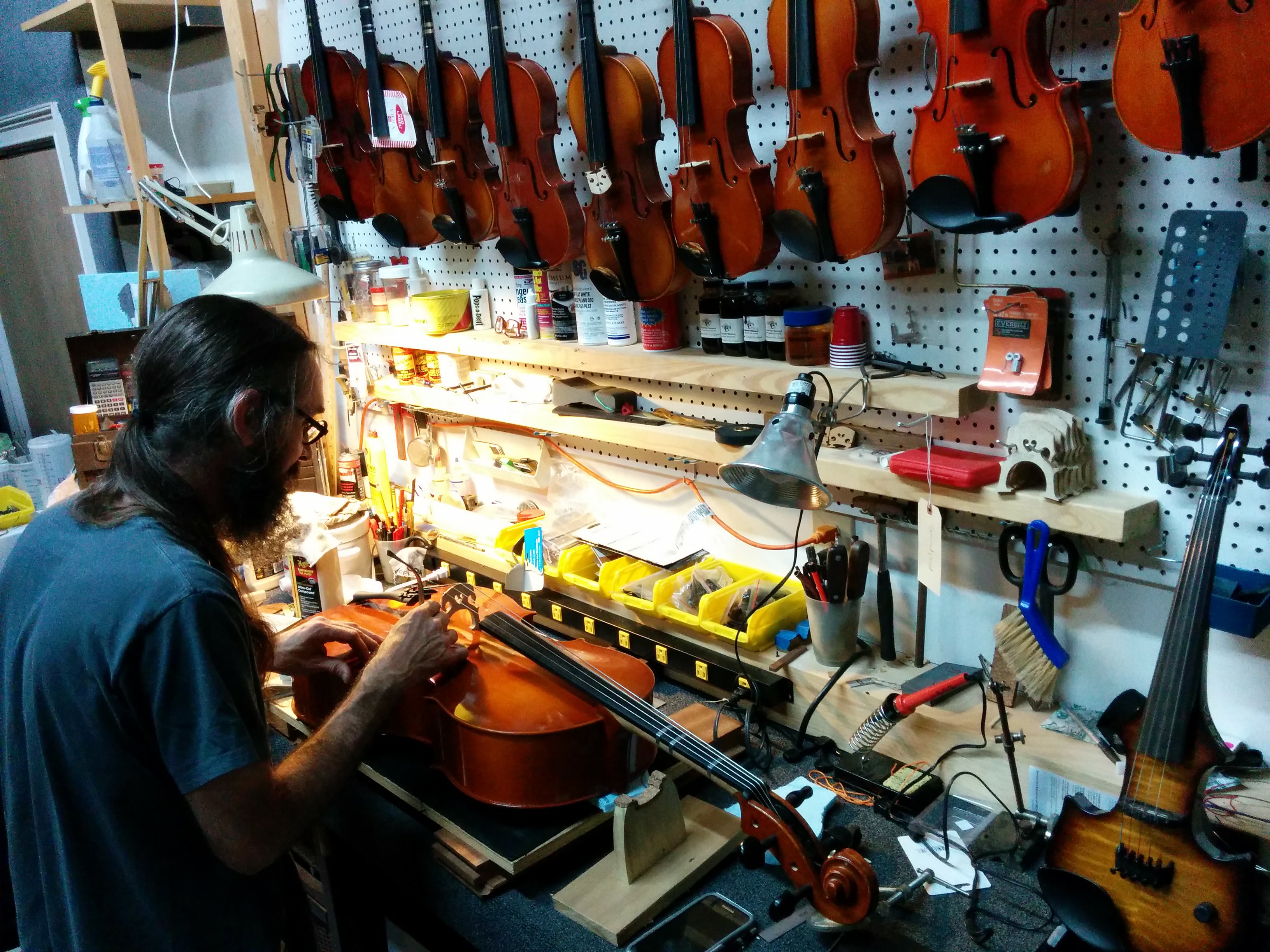 Instrument repair technician working at the bench